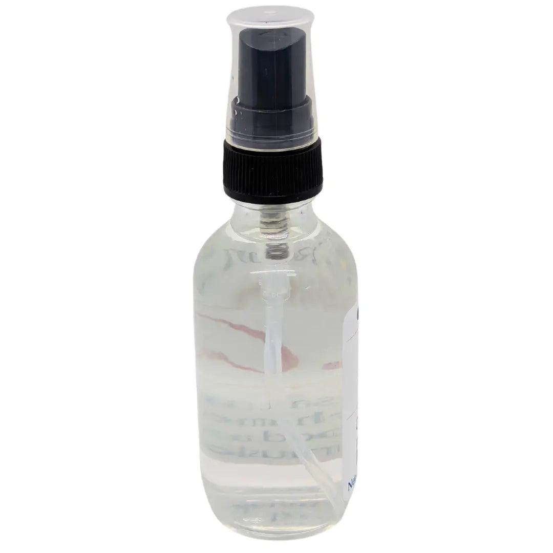 Clear glass spray bottle with black nozzle, filled with clear liquid. ResilScents Room Spray.