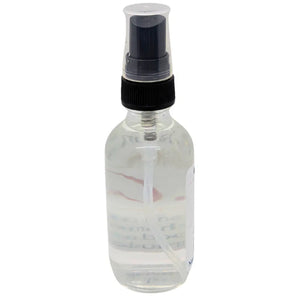 Clear glass spray bottle with black nozzle, filled with clear liquid. ResilScents Room Spray.