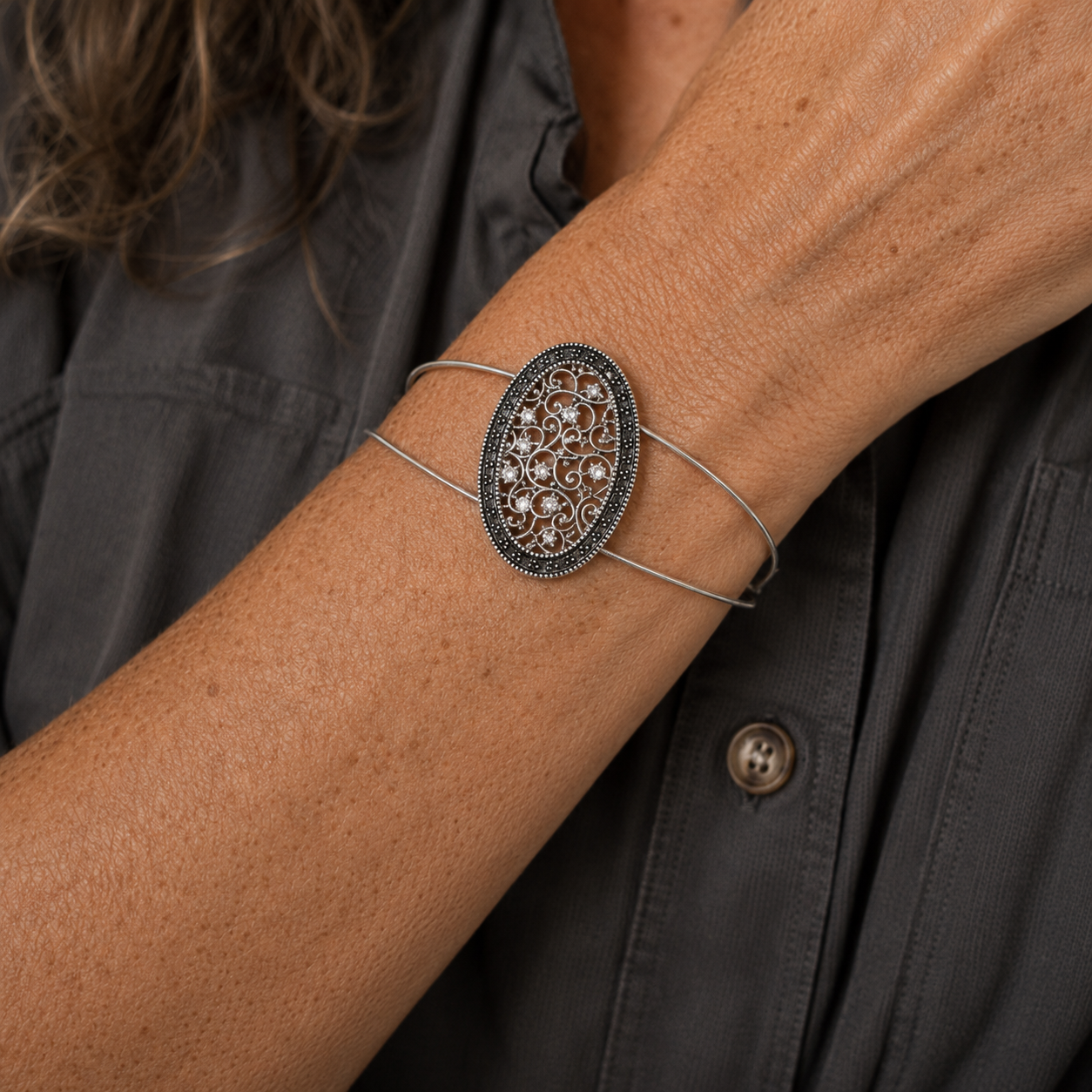 Vintage inspired silver filigree oval bracelet on wrist