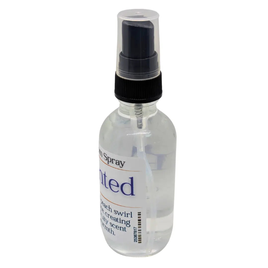 Bottle of ENCHANTED™ RESILMIST™ room spray with a clear bottle, black spray nozzle, and a product label.