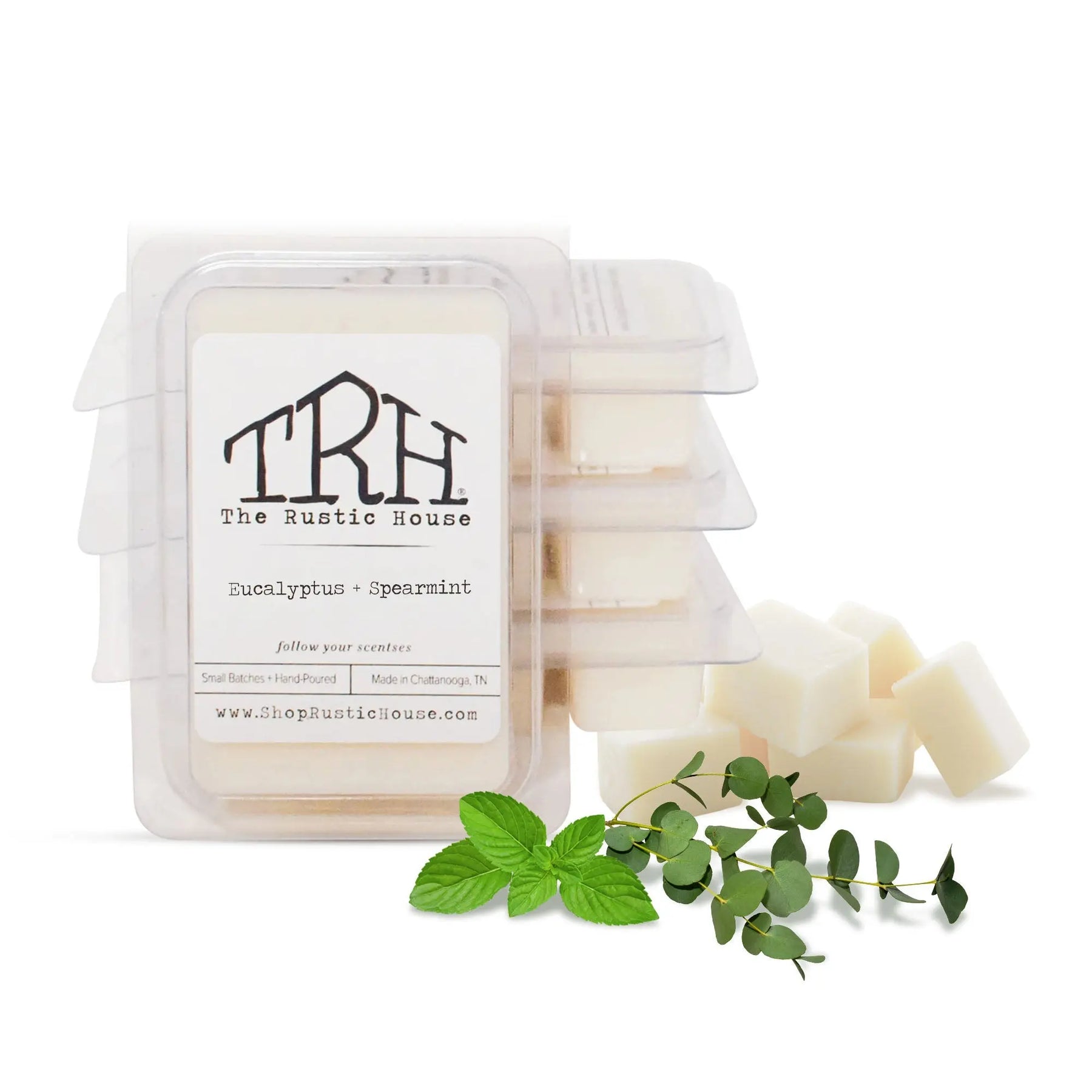 The Rustic House Eucalyptus + Spearmint wax melt with mint and eucalyptus sprigs.
