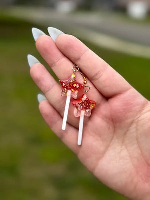Handmade fairy earrings: Red resin star candy lollipop earrings. Whimsical fairycore jewelry by Mushroom Lady Co.