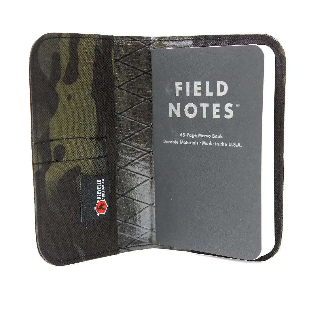 Field Notes notebook wallet with camouflage pattern and "Recycled Firefighter" tag.