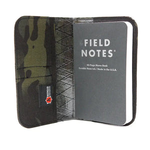 Field Notes notebook wallet with camouflage pattern and "Recycled Firefighter" tag.