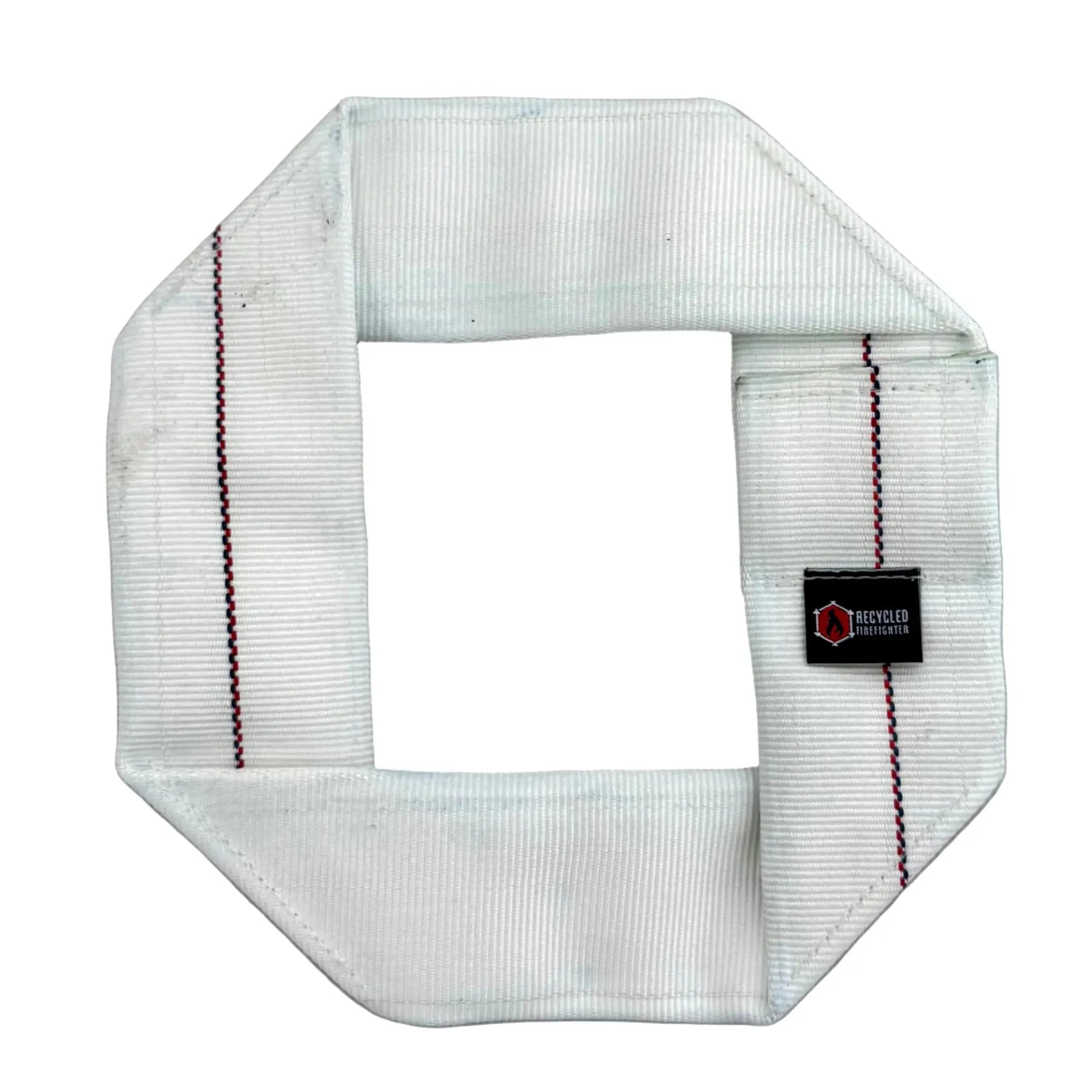 Octagonal white fire hose dog frisbee with red and blue stripes and a black label.