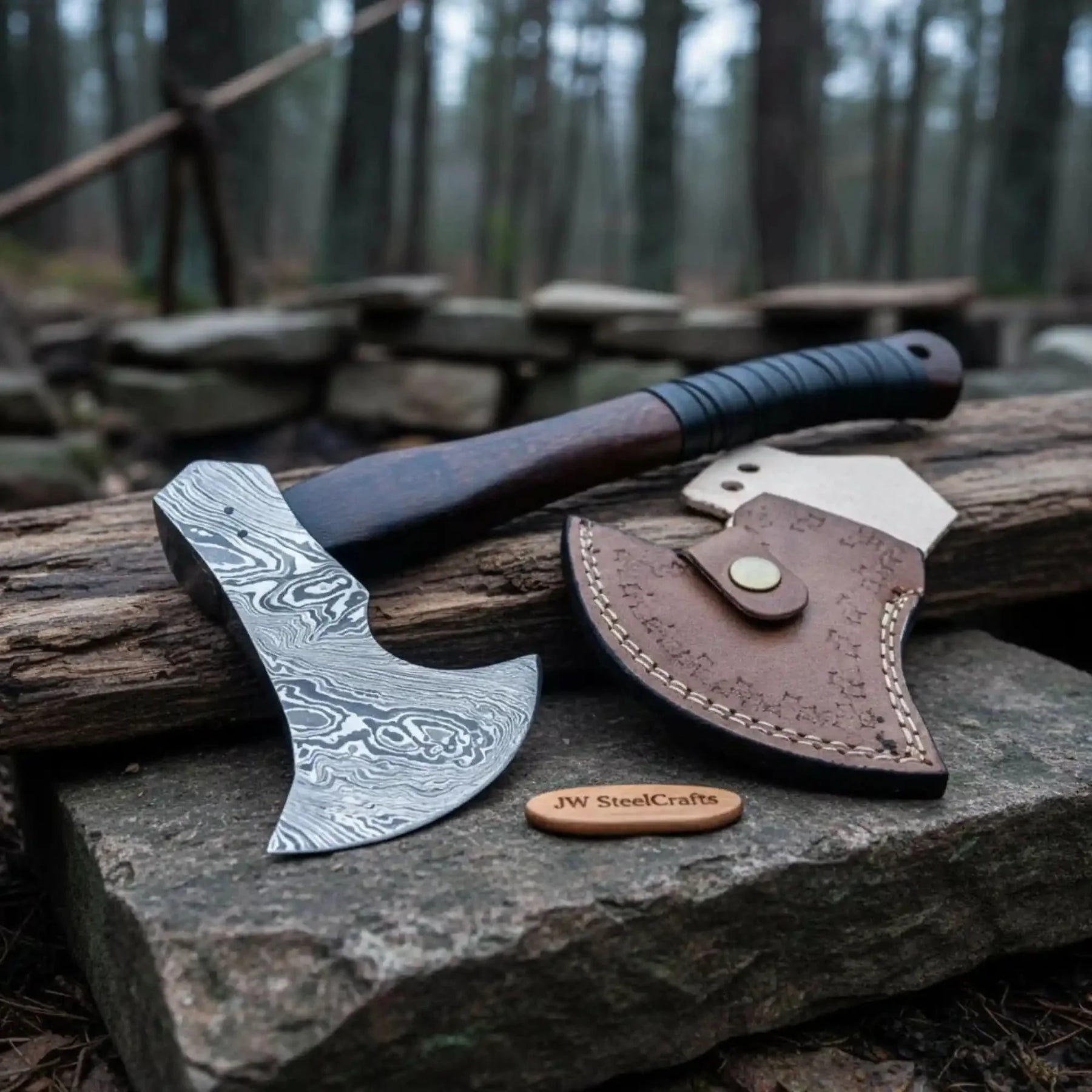 Damascus steel axe head with wood handle on rustic wood surface