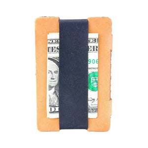 Full grain leather card wallet with black silicone cash strap holding US dollar bills.