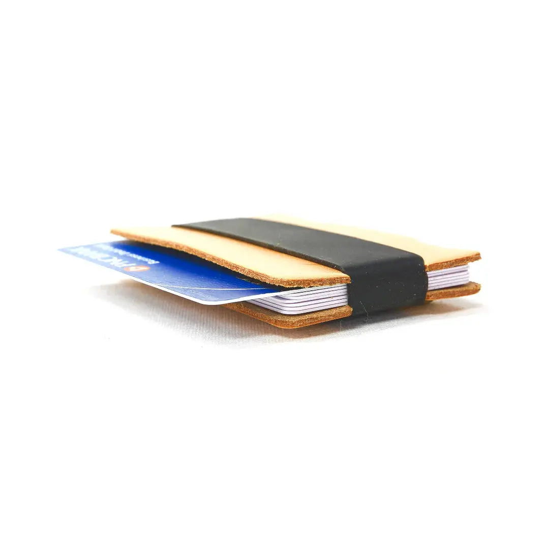 Full grain leather card wallet with elastic band holding credit cards.