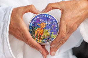 Ginger Quince Body Butter with Goats Milk label held by hands.