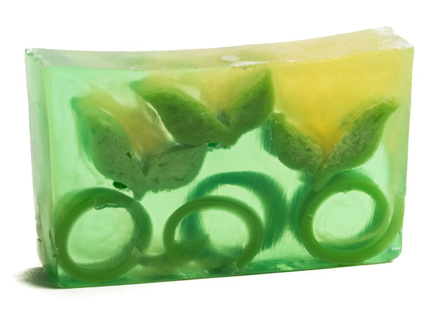 Green tea soap slice with embedded floral shapes and swirl designs.