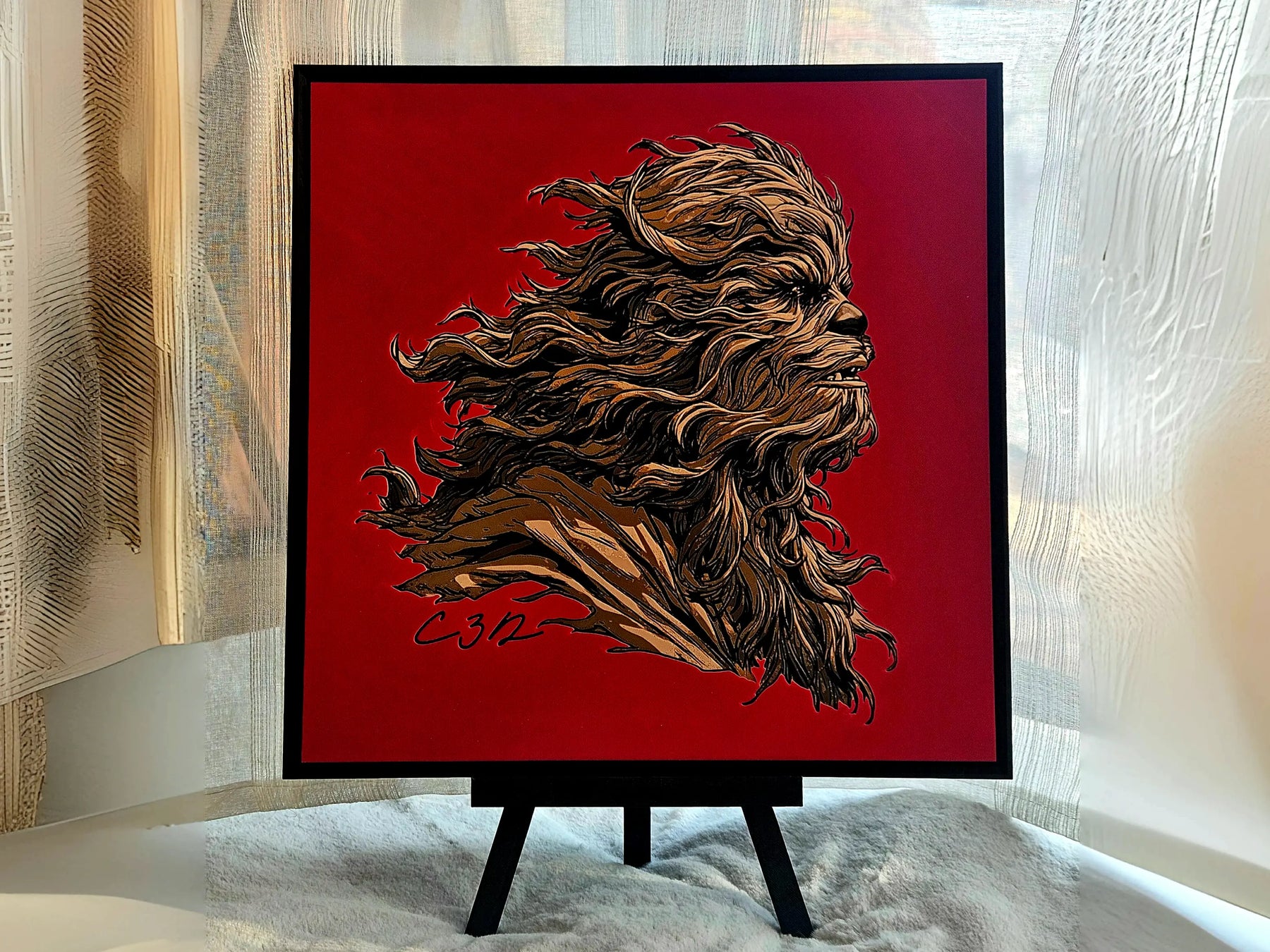 Chewbacca-inspired portrait on a desk easel. Sci-fi wall art of a Wookiee-like character in brown on a red background, signed C312.