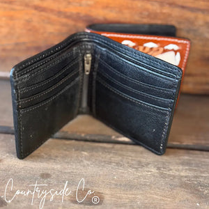 Open black leather men's wallet with zippered compartment and card slots on a wooden surface.