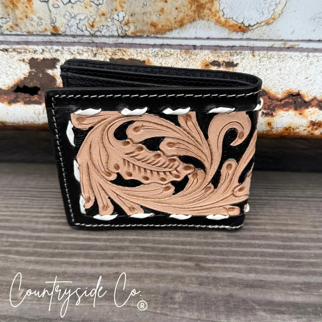 Black leather men's wallet with intricate tan tooling and white stitching