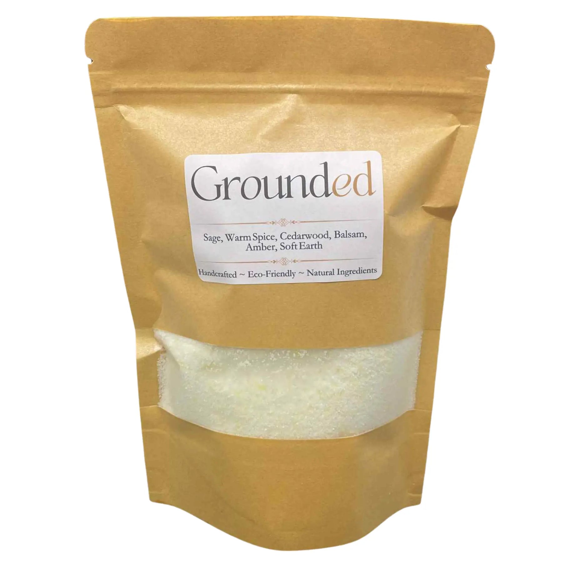 Pouch of "Grounded" laundry detergent with "Earthy Woods & Amber" scent, showing product through clear window.