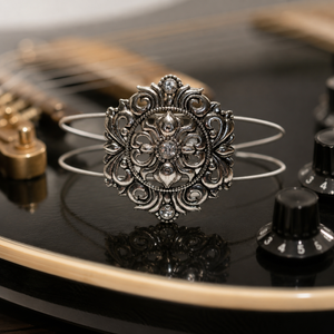 Silver medallion guitar string bracelet on guitar