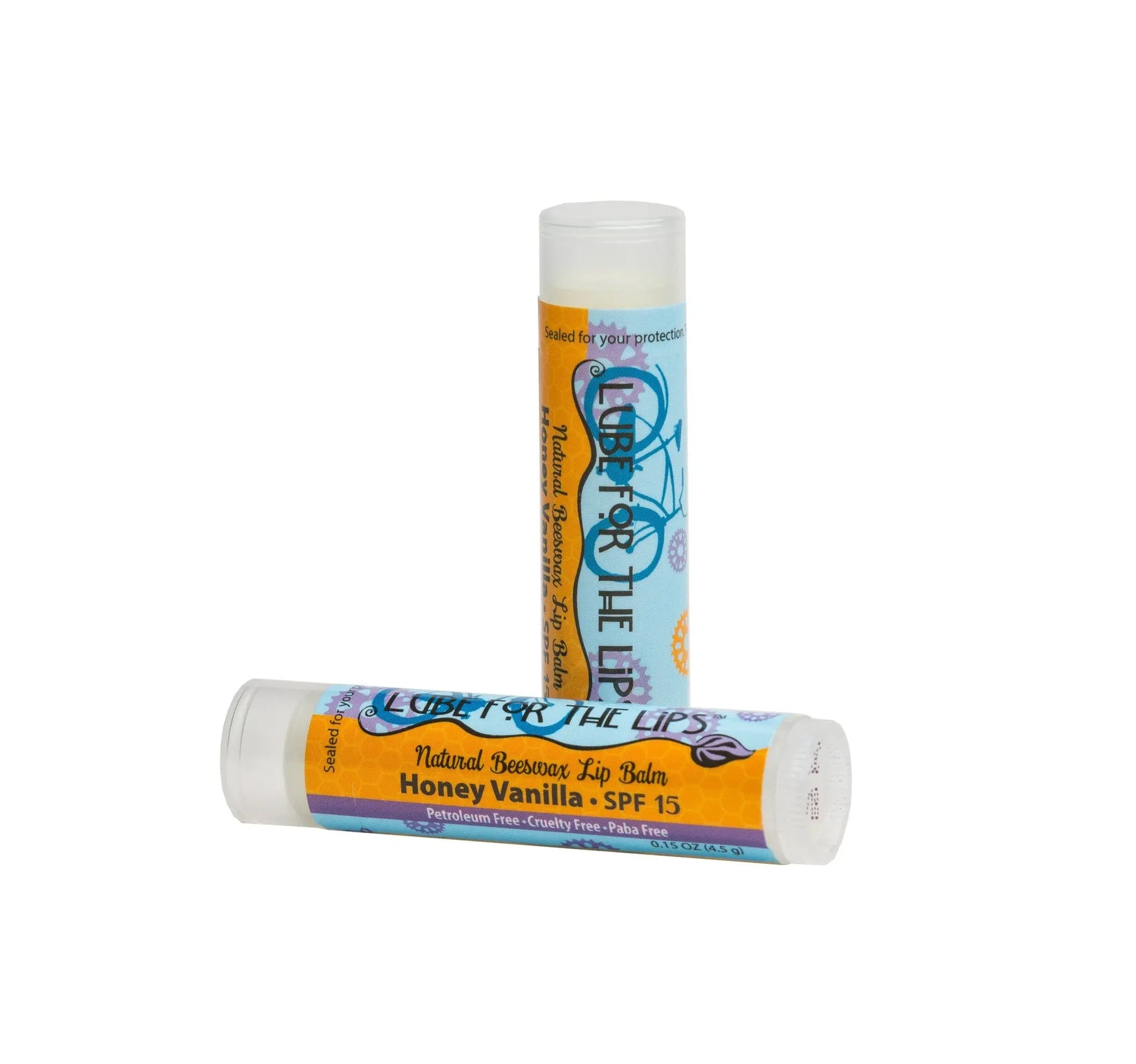 Two lip balm tubes, one upright and one lying down, with "LUBE FOR THE LIPS" labels.