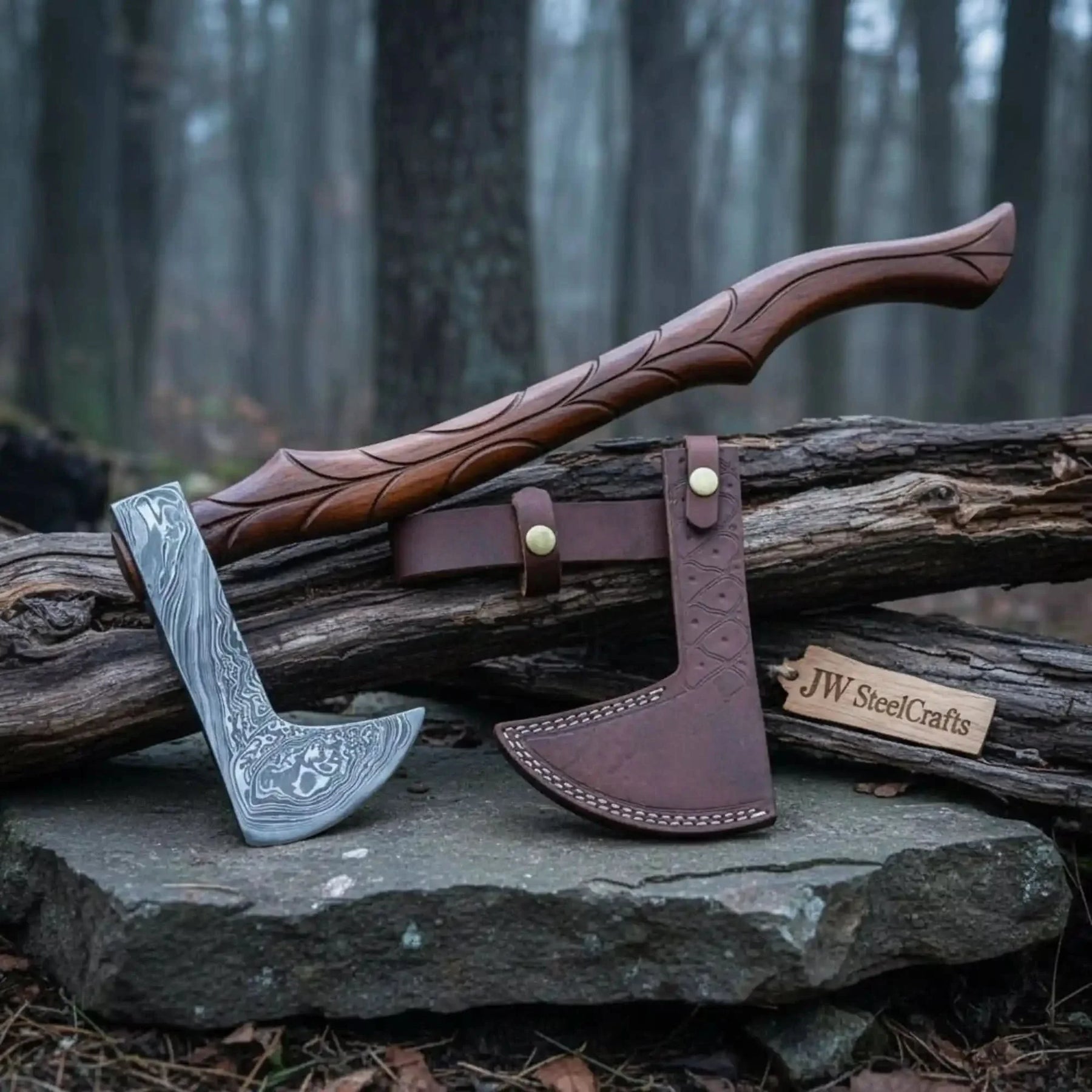 Damascus steel axe head with leather handle on rustic wood surface