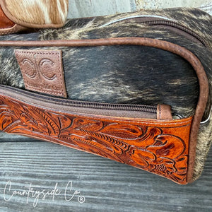 Toiletry bag with tooled leather front and cowhide body.