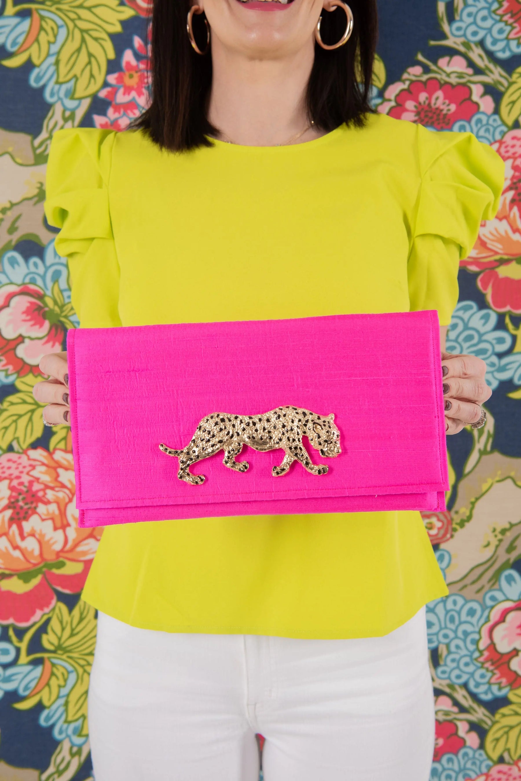 Hot pink clutch with gold leopard embellishment and ruffled sleeve blouse.