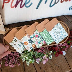 Phone wallet with houseplant patterns and tan leather top