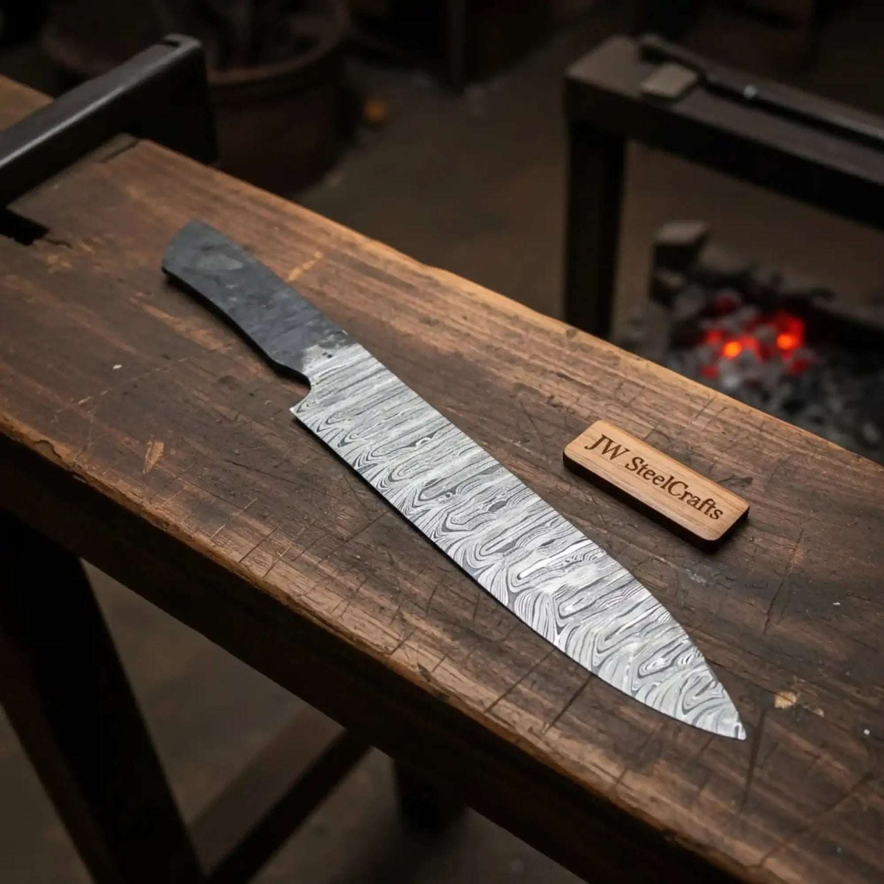 Handmade damascus steel knife with premium handle on dark surface