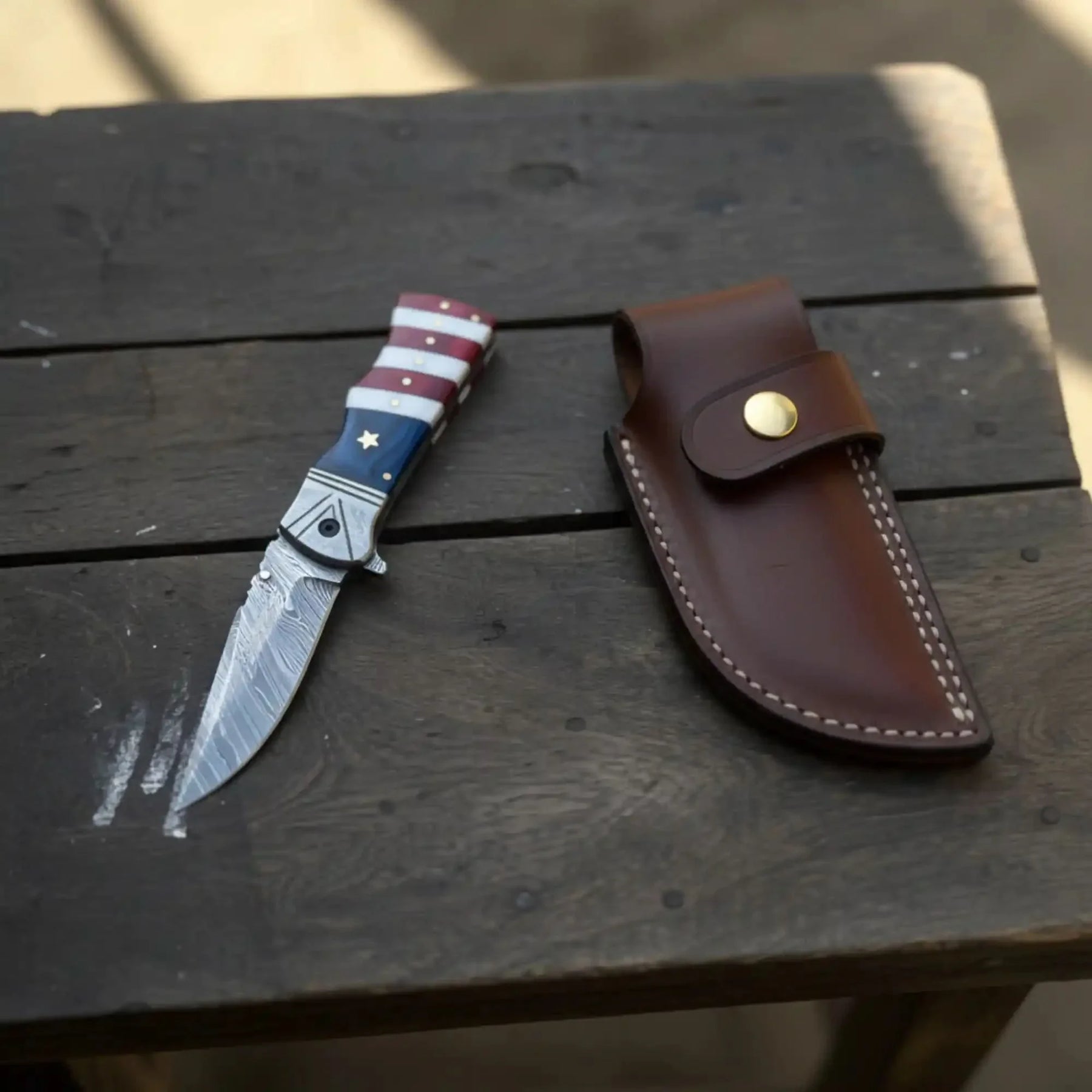 Damascus Folding Pocket Knife — American Flag Handle, Damascus Bolster, Linear Lock & Hand Engraved Leather Sheath