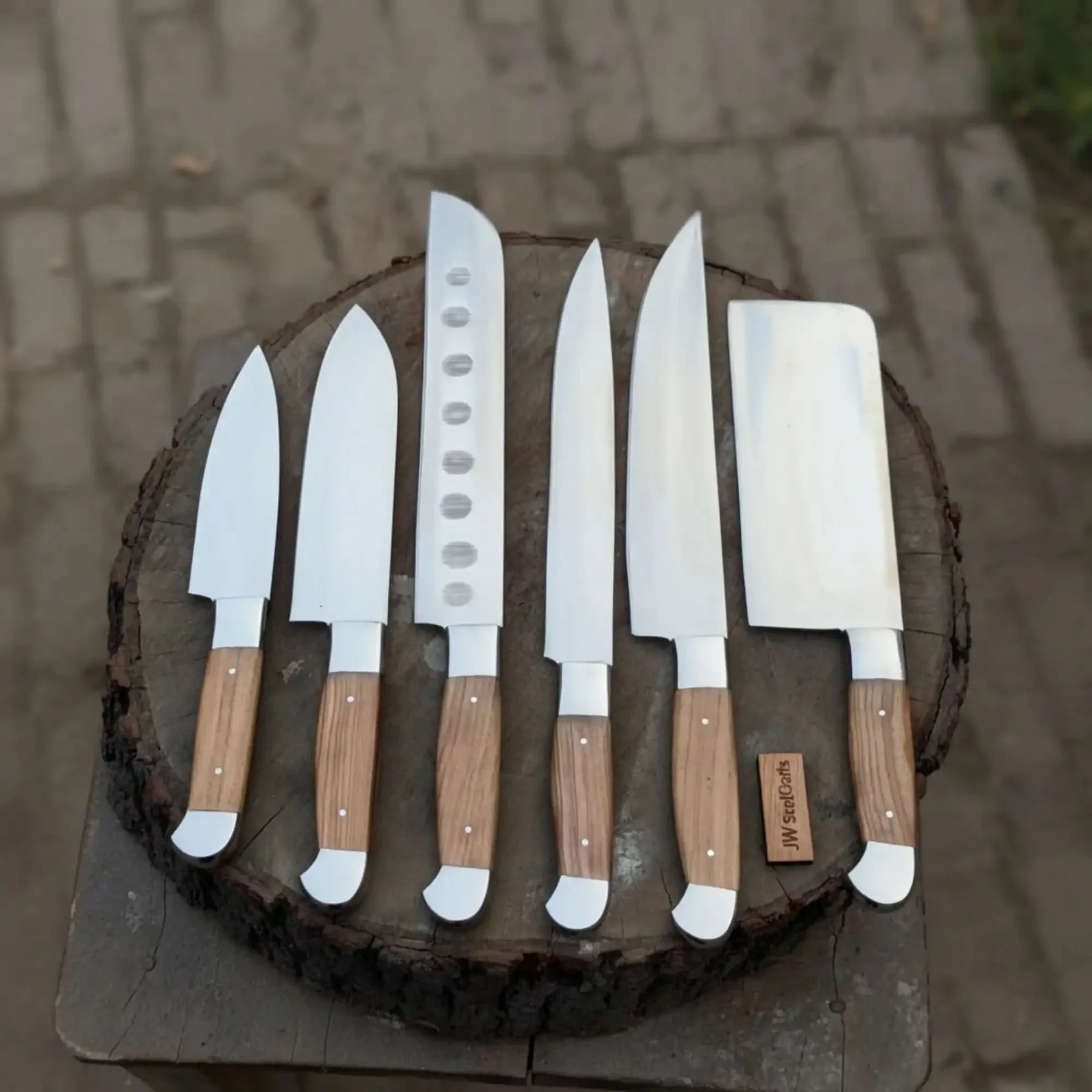 Handmade stainless steel steel knife with wood handle on dark surface