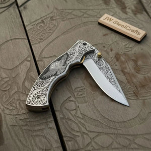 Hand Engraved Folding Knife — Eagle Motif Stainless Steel Scales, Mirror Polish Blade, Liner Lock, Wooden Box & Viking Rune Bracelet