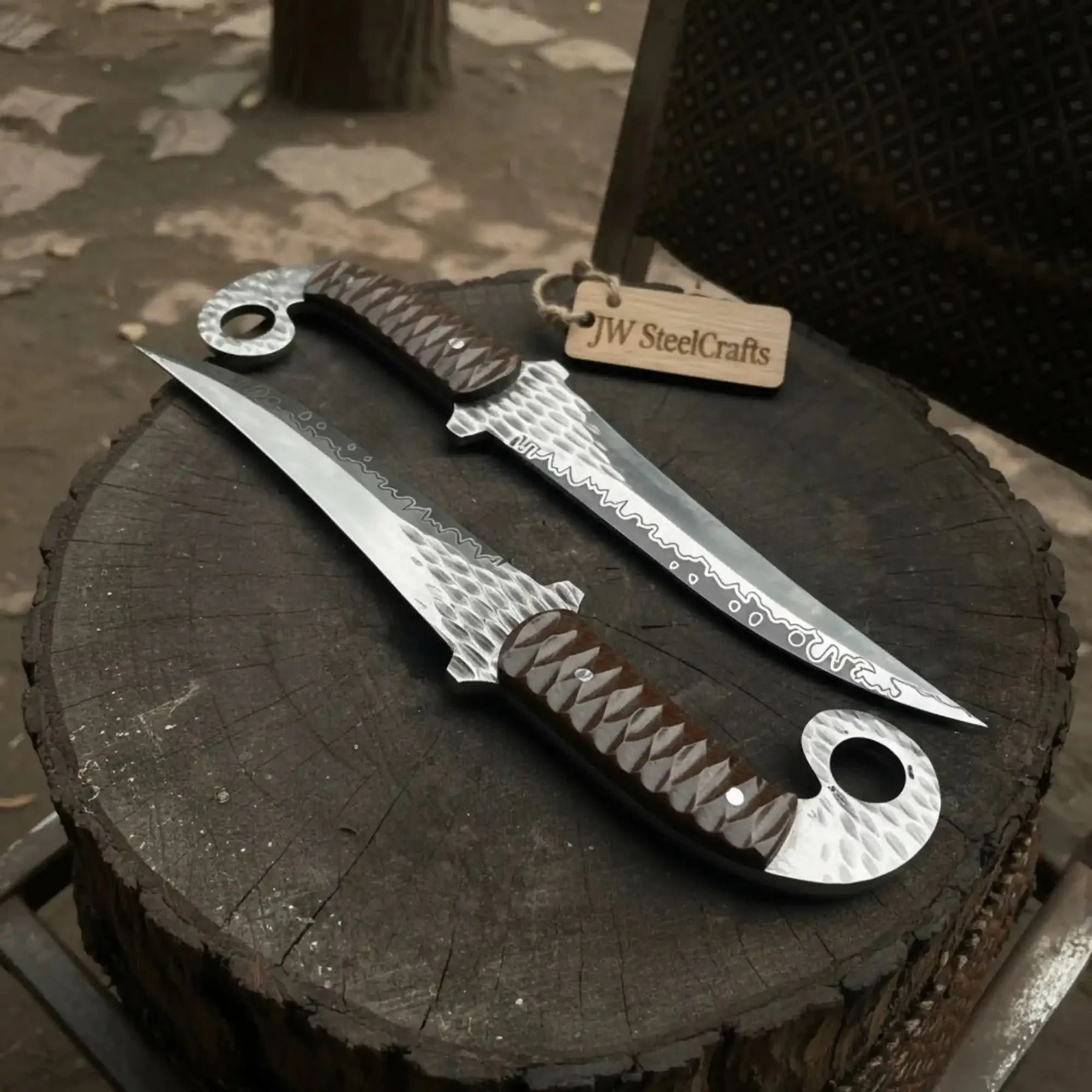 Handmade damascus steel knife with premium handle on dark surface