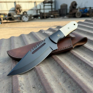 Handmade damascus steel knife with premium handle on dark surface