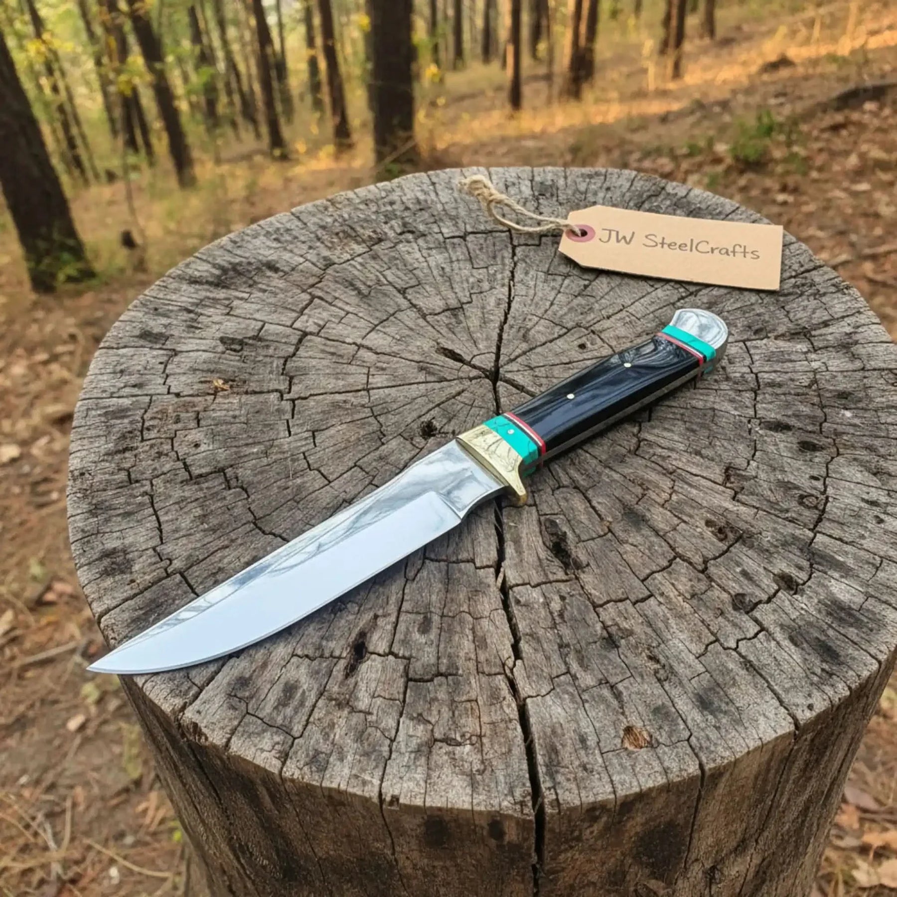 Handmade carbon steel steel knife with horn handle on dark surface