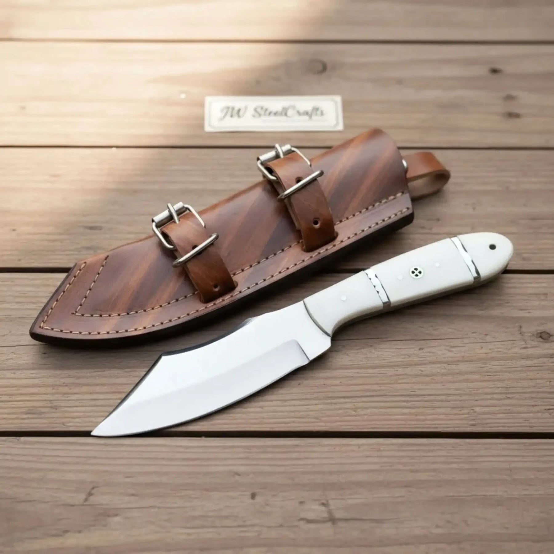 Handmade carbon steel steel knife with resin handle on dark surface