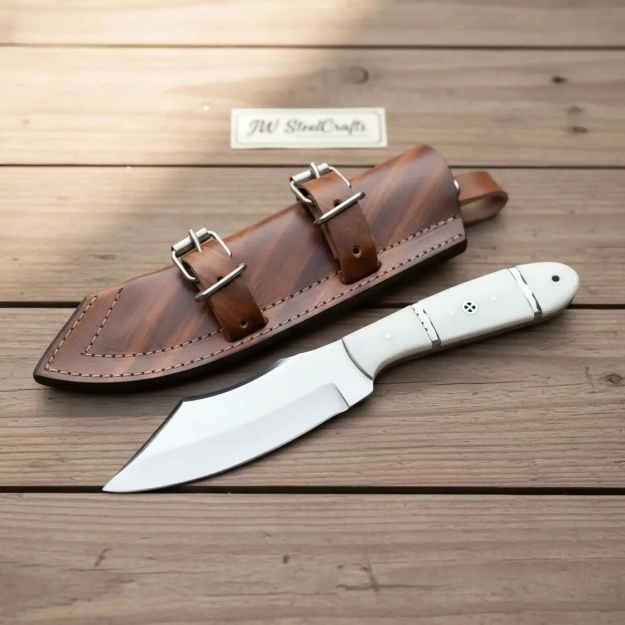 Handmade carbon steel steel knife with resin handle on dark surface