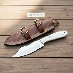 Handmade carbon steel steel knife with resin handle on dark surface