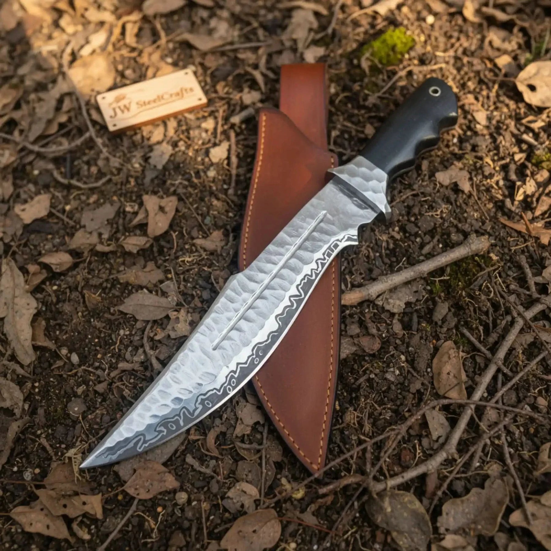 Handmade carbon steel steel knife with resin handle on dark surface