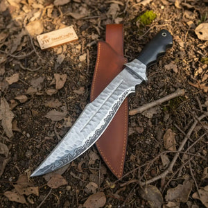 Handmade carbon steel steel knife with resin handle on dark surface