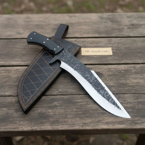 Handmade carbon steel steel knife with micarta handle on dark surface