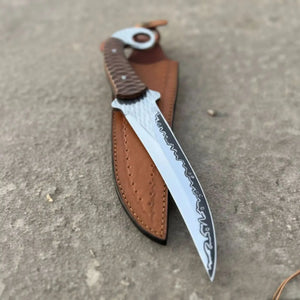 Handmade damascus steel knife with premium handle on dark surface