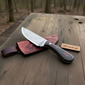 Handmade damascus steel knife with premium handle on dark surface