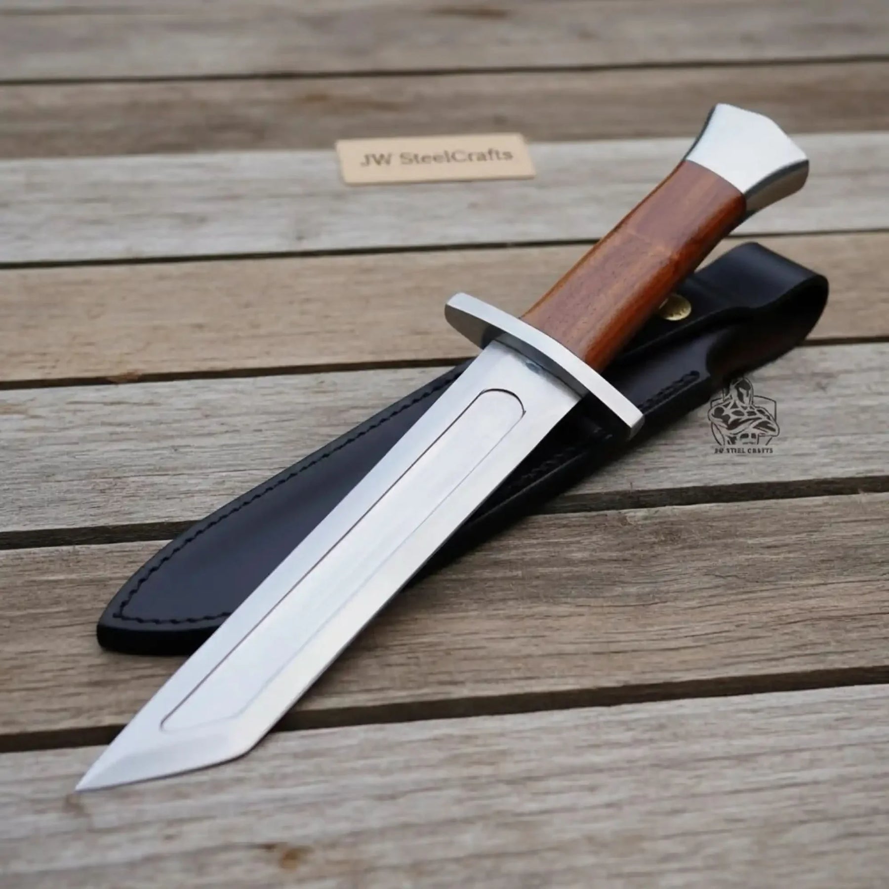 Handmade carbon steel steel knife with wood handle on dark surface