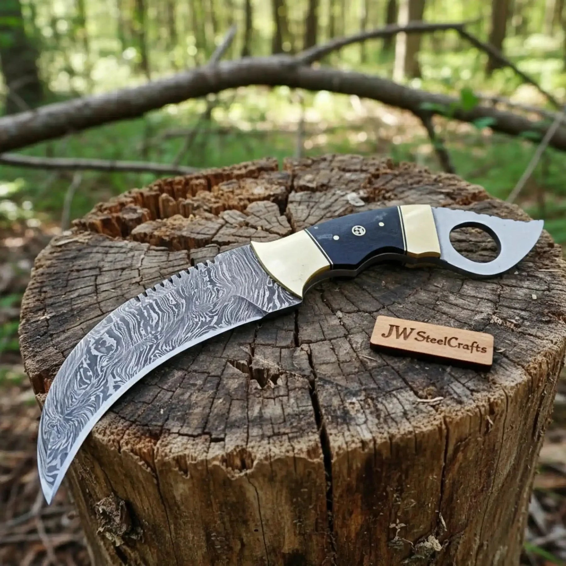 Handmade damascus steel knife with premium handle on dark surface