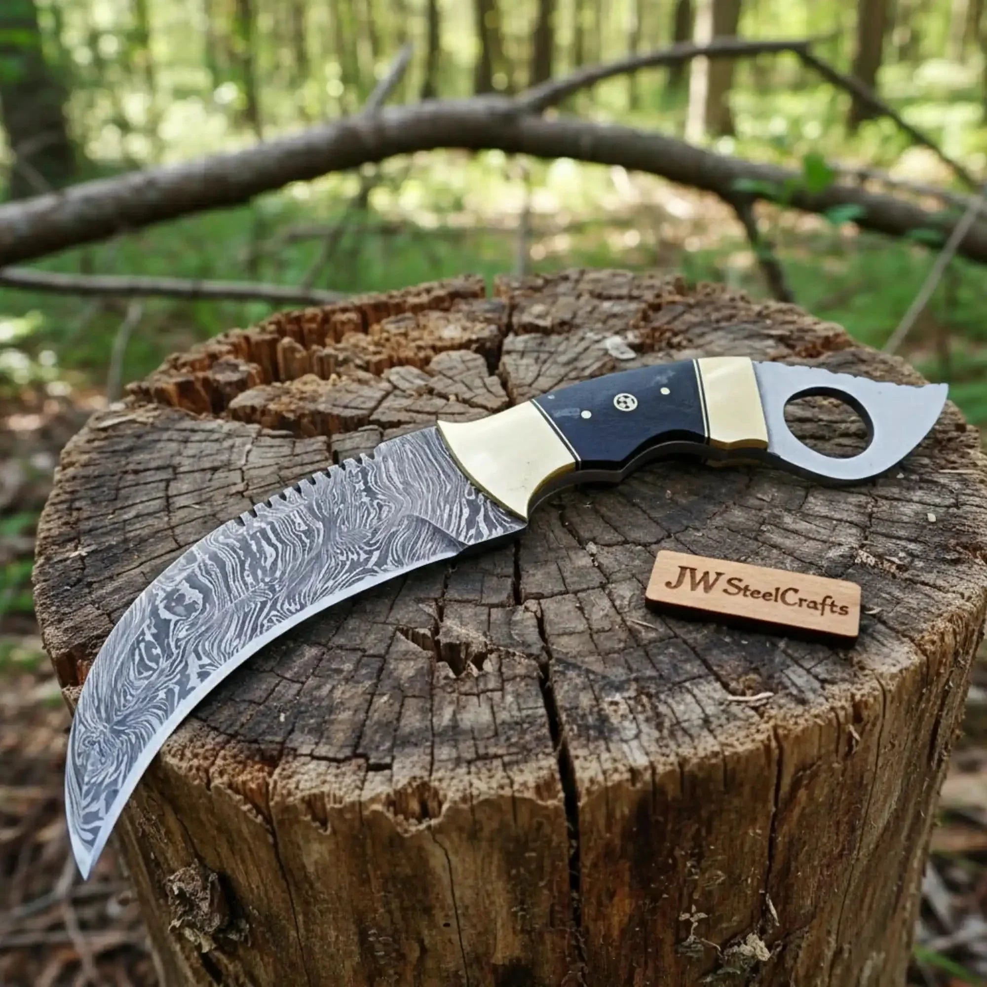Handmade damascus steel knife with premium handle on dark surface