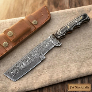 Handmade damascus steel knife with wood handle on dark surface