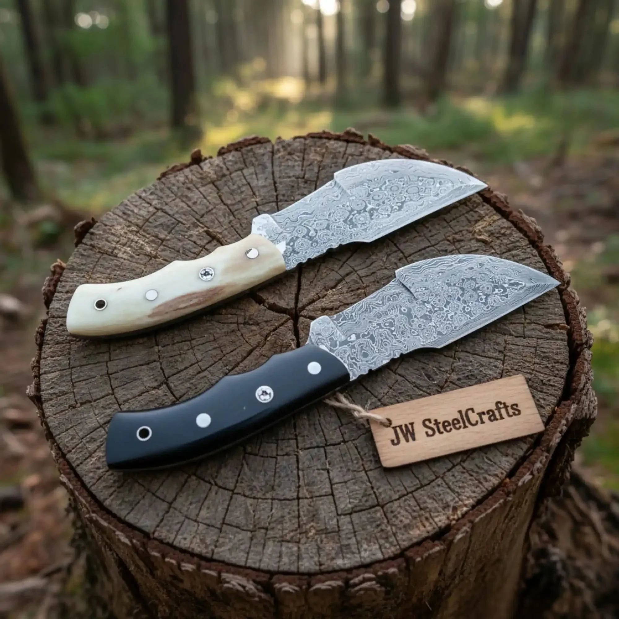 Handmade damascus steel knife with bone handle on dark surface