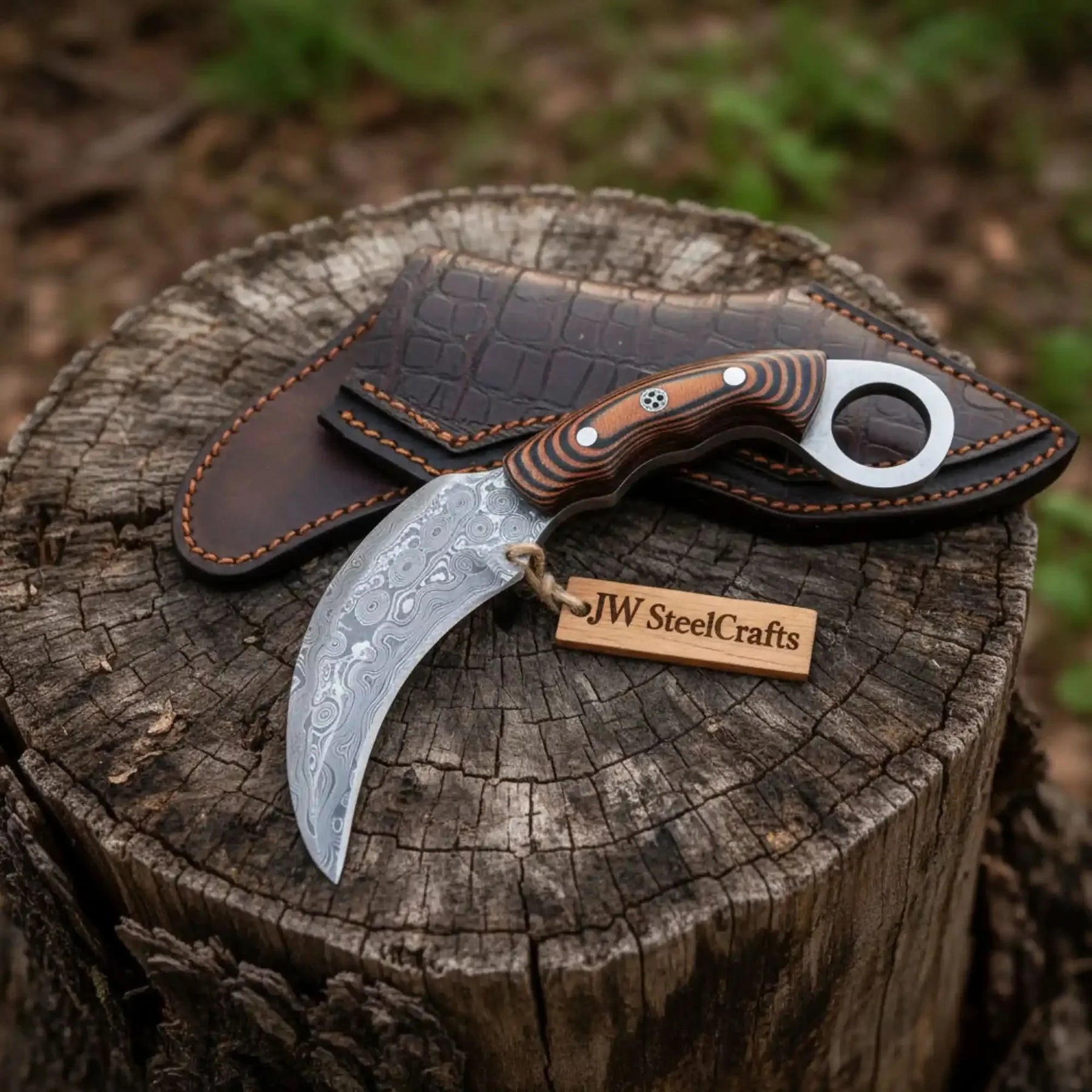 Handmade damascus steel knife with micarta handle on dark surface