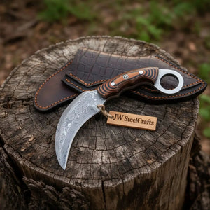 Handmade damascus steel knife with micarta handle on dark surface
