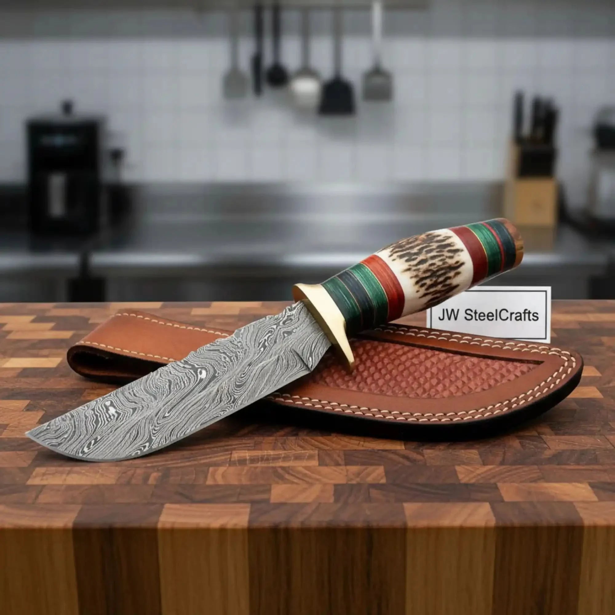 Handmade damascus steel knife with wood handle on dark surface