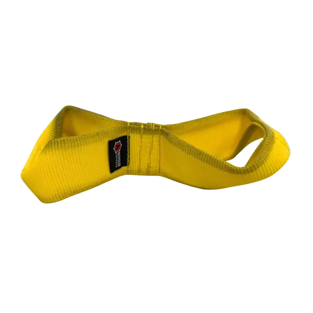 Yellow double-loop firehose dog tug toy with a black tag.