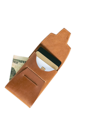 Brown leather card wallet with credit cards and twenty dollar bill against black background