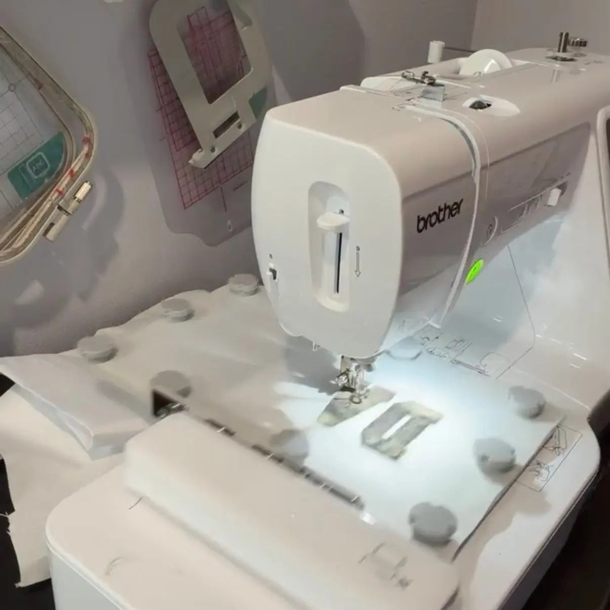 Brother sewing machine with fabric and appliqué pieces.